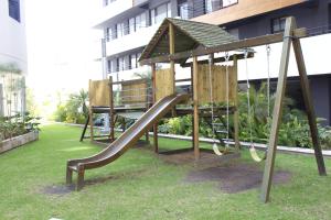 a playground with a slide in front of a building at Suites Metropoli Bristol Parc in Quito