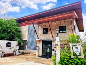 un edificio con una señal delante de él en Doi Samoe Dao Hostel, en Nan