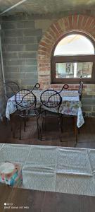 a table and chairs in a room with a window at Owczarkowa Zagroda 