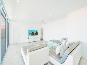 a living room with two white couches and a tv at Villa Maviela Sea View 2 Bdr in Koh Samui 