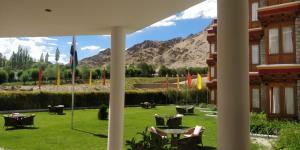 a view of the mountains from the courtyard of a hotel at The Druk Ladakh in Leh +9 photos