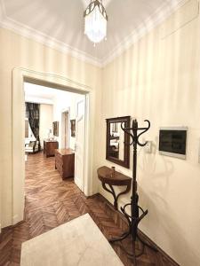 a living room with a table and a mirror at Premium Timisoara in Timişoara