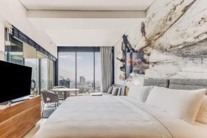 a bedroom with a large bed and a large window at Live Aqua Monterrey in Monterrey