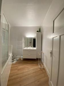 bagno bianco con lavandino e specchio di NOUVEAU !!! Appartement cosy tout confort à deux pas de Strasbourg a Schiltigheim