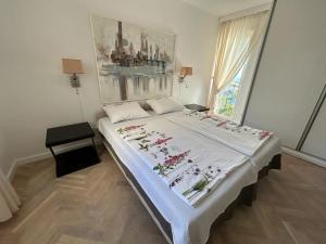 a bedroom with a large bed with flowers on it at Apartments Villa Manda in Novi Vinodolski +34 photos