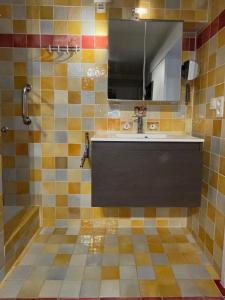 uma casa de banho com um lavatório e um chuveiro com um espelho. em La Rabasse de Gallinette em Aups