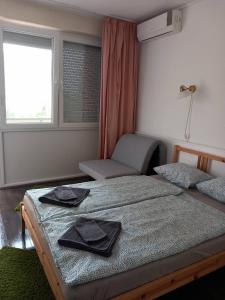 シオーフォクにあるCuki Apartmanokのベッドルーム1室(黒いナプキンが付いたベッド1台付)