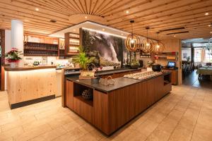 a large kitchen with a island in a restaurant at Hotel Krimmlerfälle in Krimml