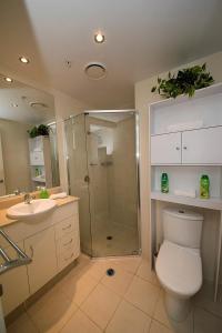 a bathroom with a shower and a toilet and a sink at ZANZIBAR FANTASTIC 1 Bedroom APARTMENT in Gold Coast