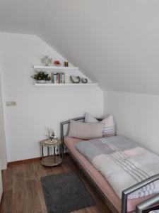 um pequeno quarto com uma cama e uma escada em Ferienhaus Rabold em Bad Liebenstein