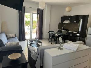 a living room with a couch and a table at Alexandros Apartments in Dhrepanon