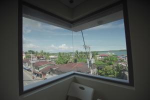 a window in a room with a view of a city at PILAR MARINA INN in Donsol
