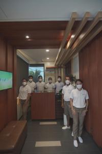 a group of people wearing face masks in a room at PILAR MARINA INN in Donsol