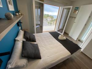 een groot bed in een kamer met een groot raam bij For a Stay Horizonte Mar in Cambrils