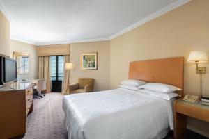 a hotel room with a large bed and a television at Sheraton Buenos Aires Hotel & Convention Center in Buenos Aires