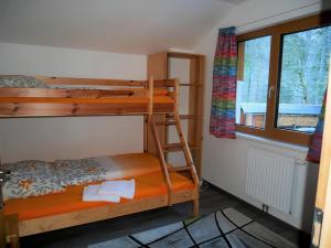 a bedroom with two bunk beds and a window at Apartment Obertraun in Obertraun