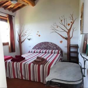 - une chambre avec un lit arboré sur le mur dans l'établissement Agriturismo Salaiolo 176, à Scansano