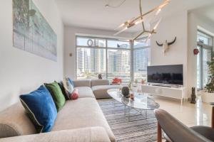 a living room with a couch and a table at Fairfield Tower, Park Island, Dubai Marina - Mint Stay in Dubai