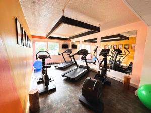 a gym with several tread machines in a room at Novotel Bordeaux Mérignac in Mérignac