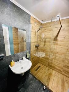 a bathroom with a sink and a shower at SeaEsta Tuzla in Tuzla
