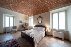 Postel nebo postele na pokoji v ubytování Cascina Baronina