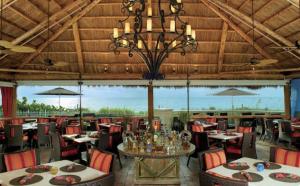 a restaurant with tables and chairs and a chandelier at Lovely Deluxe Unit Located at Ritz Carlton - Key Biscayne! in Miami