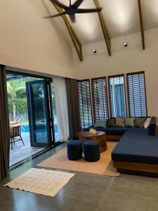 a living room with a couch and a table at 04-Biệt thự cao cấp Hồ Tràm-3BR SUPER KINGS, Hồ bơi to,BBQ, cầu ra ngắm biển in Xuyên Mộc +61 photos