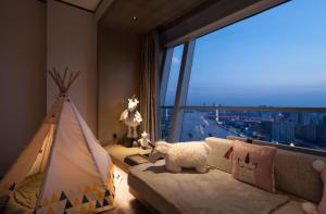 a room with a couch and a large window at JW Marriott Marquis Hotel Shanghai Pudong in Shanghai