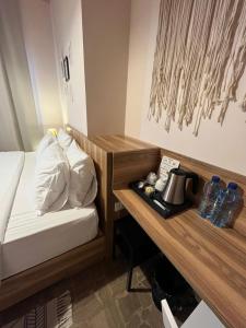 a hotel room with a bed and a desk with a coffee maker at Beit Mirna Guesthouse & Chalet - Ehden in Ehden +62 photos