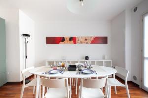 a white dining room with a white table and chairs at Casa Pozzetto - Cittadella in Cittadella