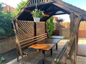 a wooden bench with a potted plant on a patio at LINAVI in Pavlohrad