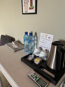 a table with a coffee maker and water bottles on it at Beit Mirna Guesthouse & Chalet - Ehden in Ehden