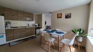 a kitchen with a table and chairs in a room at Lake Resort in Sárkeresztes