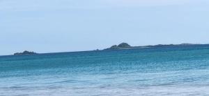 a view of the ocean with islands in the distance at Hotel Coral Bay in Trincomalee