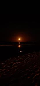 a sunset on the beach with the sun setting at Hotel Coral Bay in Trincomalee