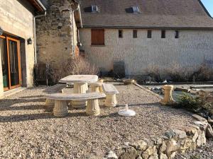 a group of picnic tables sitting in a yard at Maison de campagne in Mens