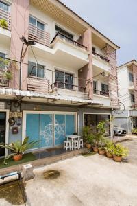 a building with a table in front of it at Turtle Rooms in Bang Tao Beach