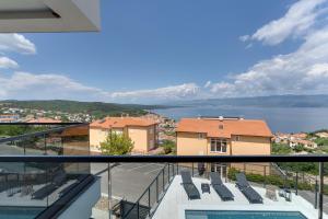 a view of the water from the balcony of a house at Luxury villa Verbenico Hills- amazing sea view, pool with whirpool and waterfall, beach, in famous wine region - Your holiday with style in Vrbnik