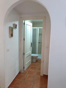 une voûte menant à une salle de bains avec toilettes dans l'établissement Casa Jaime, à Monachil