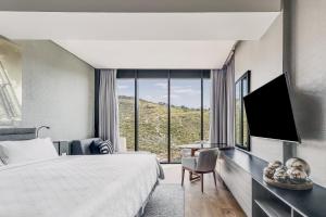 a hotel room with a bed and a large window at Grand Fiesta Americana Monterrey Valle in Monterrey