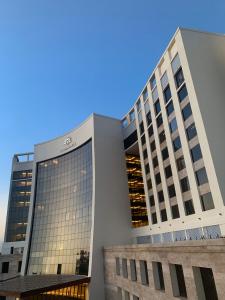 two tall buildings with a blue sky in the background at Bravia Hotel Niamey in Niamey