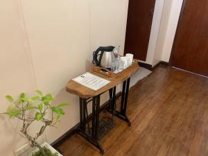 a table with a coffee maker on top of it at Casa Don Julian Guesthouse in Bais