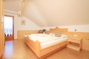 a bedroom with a large wooden bed in a room at Oberhuberhof in Rodengo