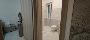 a bathroom with a toilet and a shower in it at Janara - Mura Longobarde in Benevento