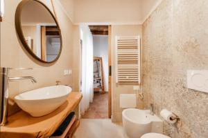 a bathroom with a white sink and a mirror at Casa Nostra - Garda Rooms in Cavalcaselle