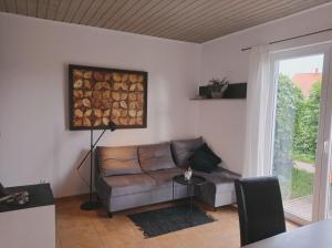 a living room with a couch and a window at Domy Nad Zalewem in Dziwnówek