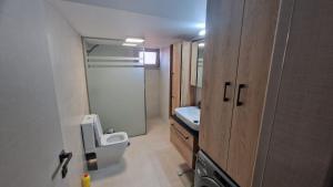 a small bathroom with a toilet and a sink at VIEW ON SCORPIOS - Ktena Accomodation in Nydri +8 photos