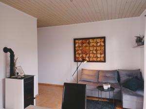 a living room with a couch and a painting on the wall at Domy Nad Zalewem in Dziwnówek