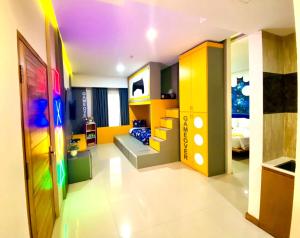 a childrens bedroom with colorful cabinets and a bed at Luminor Hotel Banyuwangi By WH in Banyuwangi