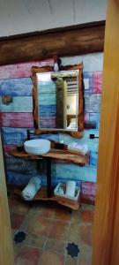 a bathroom with a sink and a mirror on a wall at La Casa de la Abuela in Cazorla